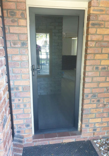 Stainless Hinged Door in Brick Wall — Security Screen Doors in Sunshine Coast, QLD