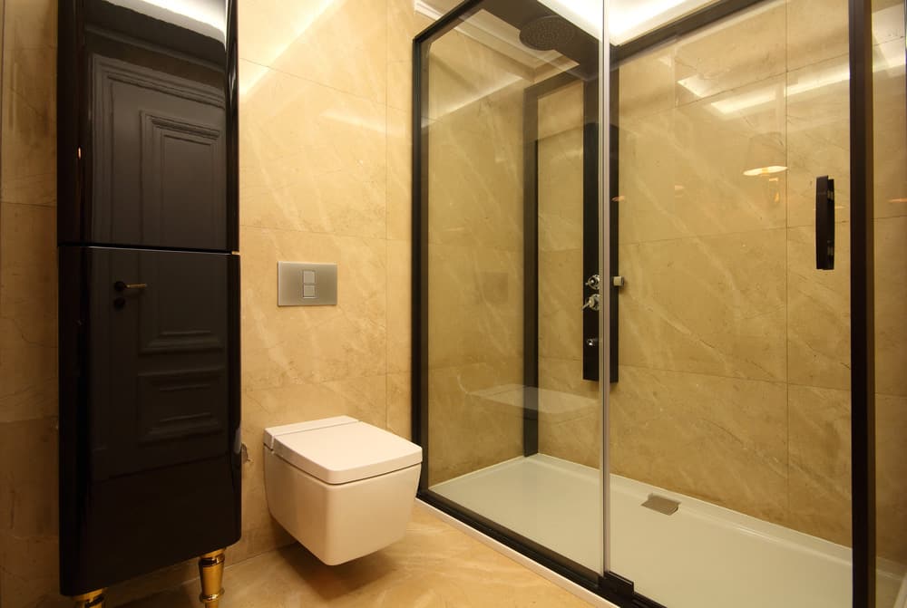 Black framed shower screen panel over bathtub