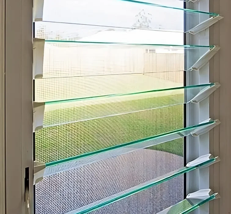 Glass louvres installed - woman looking out of windows - louvres sunshine coast